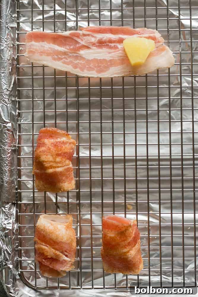 Assembling brown sugar bacon wrapped pineapple bites, showing a wrapped piece being rolled in sugar