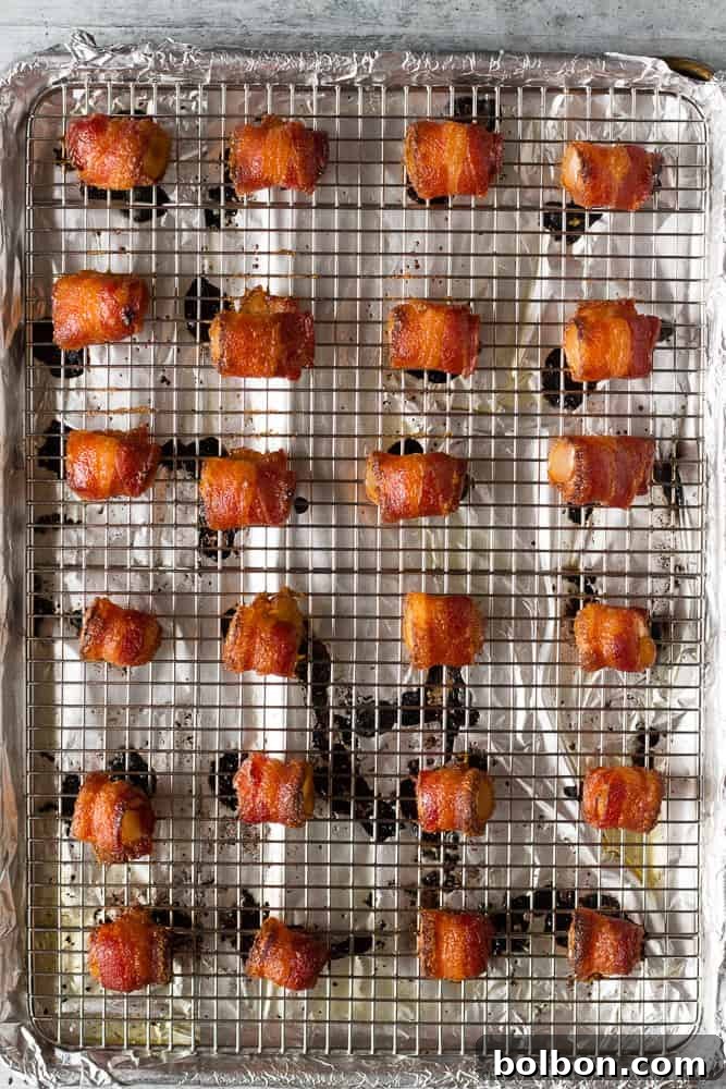 A tray of freshly baked brown sugar bacon wrapped pineapple bites, golden and crispy