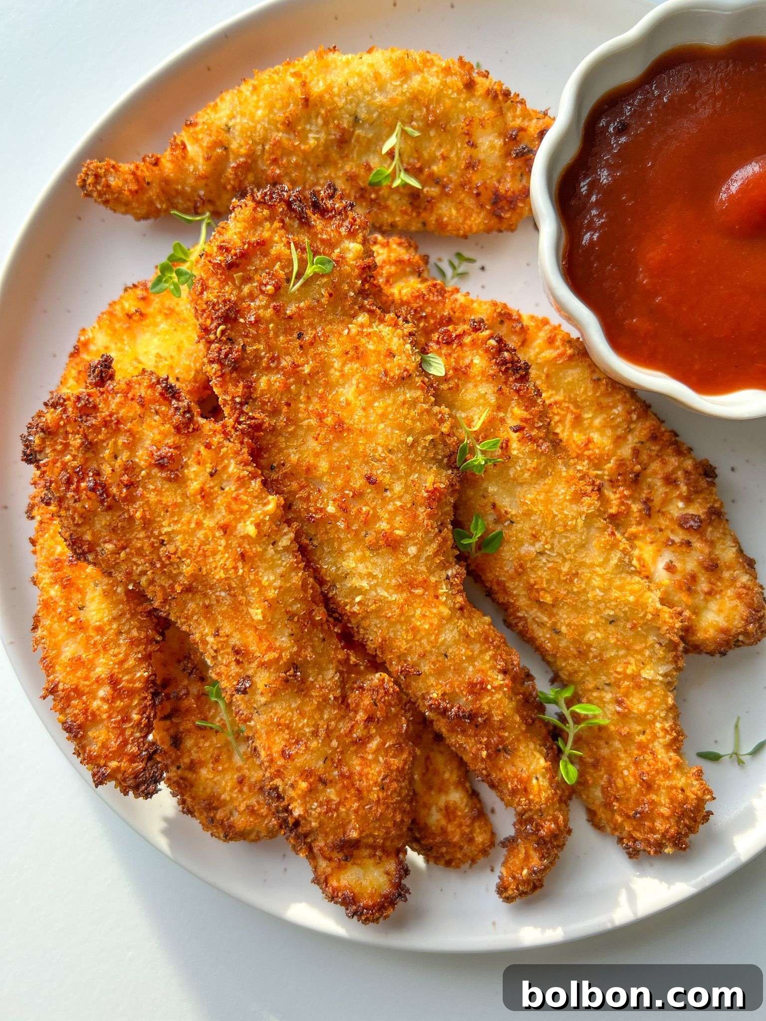 Golden Chicken Strips 3 Crispy Chicken Fingers artfully arranged on a plate, highlighting their golden texture and enticing presentation, ready to be enjoyed.