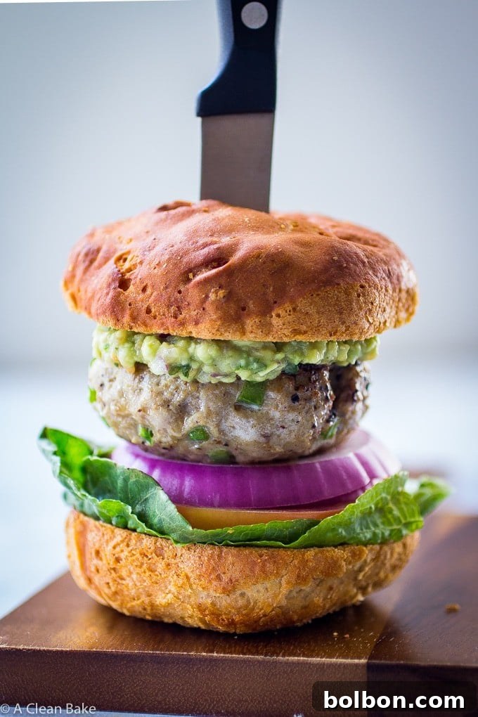 Jalapeño Burger recipe from A Clean Bake A close-up of a delicious Jalapeño Burger, showing a juicy patty with melted cheese, jalapeños, and fresh toppings on a bun, representing quick and spicy ground beef recipes.