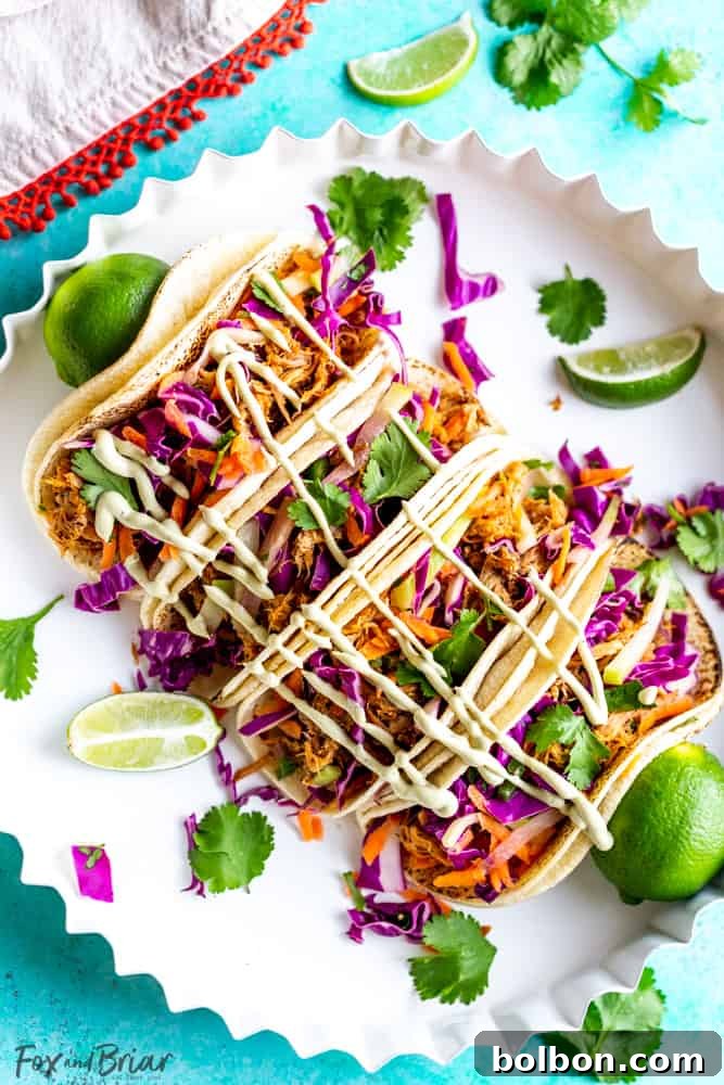 Slow Cooker Mexican Pulled Pork Tacos Juicy Slow Cooker Mexican Pulled Pork Tacos with fresh cilantro lime slaw and creamy avocado crema, served on a soft tortilla. A perfect meal for feeding a crowd or an easy weeknight dinner.
