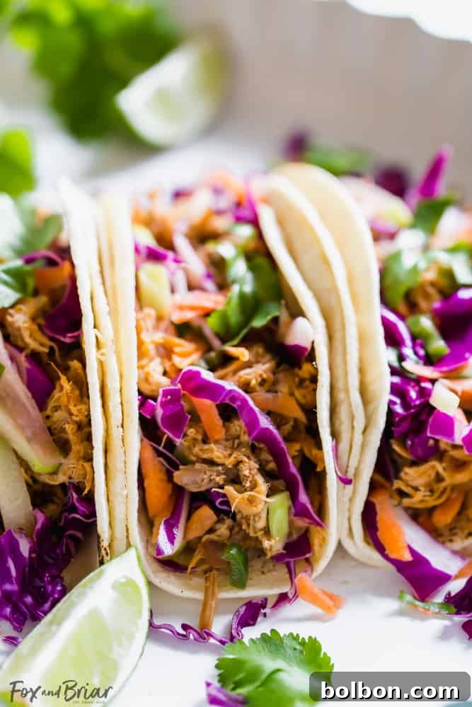 Slow Cooker Mexican Pulled Pork Close-up of slow cooker pulled pork, ready to be shredded for Mexican tacos. The pork is tender and seasoned with traditional spices.