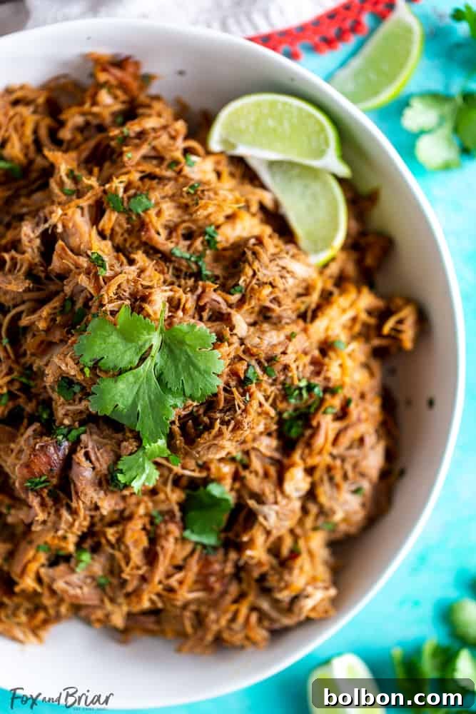 Crispy Slow Cooker Pork Carnitas 7 A vibrant platter of Slow Cooker Pork Carnitas tacos, garnished with cilantro, onions, and lime. A perfect meal for family and friends.