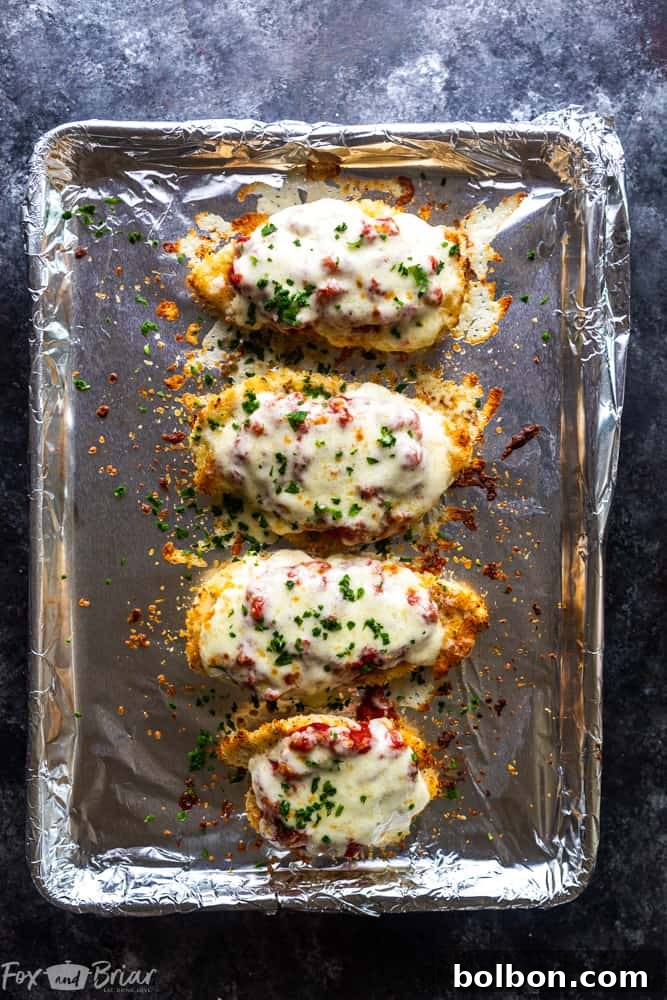 Close-up of crispy Oven Baked Chicken Parmesan, emphasizing its healthy, quick, and easy preparation without frying. A delicious dinner recipe perfect for a copycat Olive Garden experience at home.