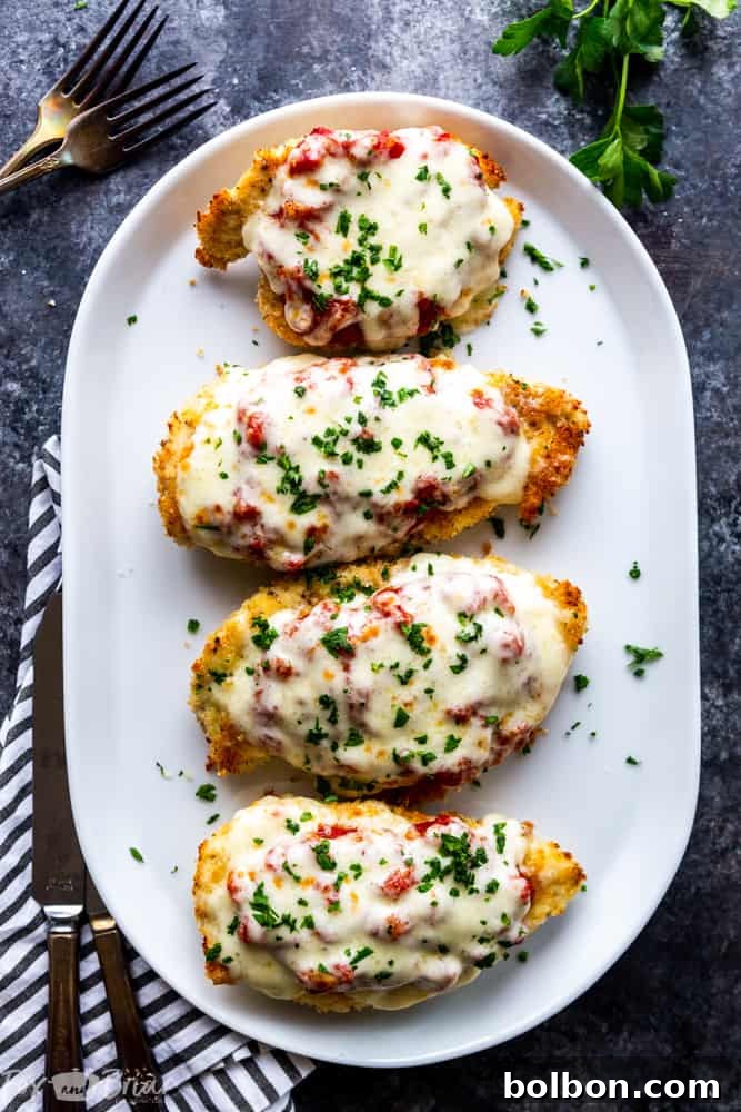 Serving suggestion for Oven Baked Chicken Parmesan, highlighting its healthy attributes. A family-friendly Italian dinner recipe ready in 30 minutes, an excellent alternative to Olive Garden Chicken Parmesan.