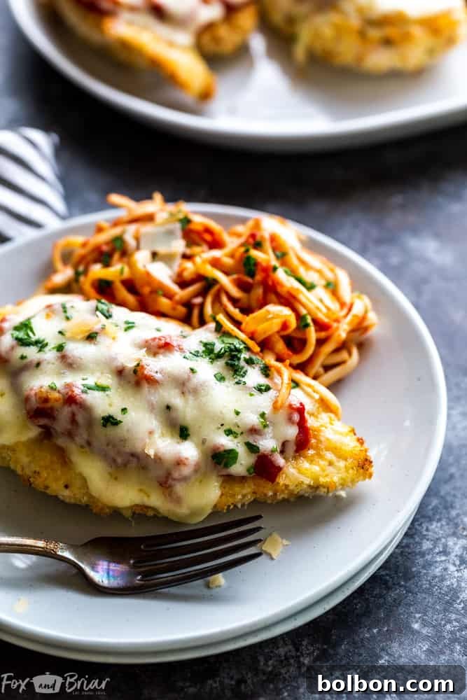 Final plated Oven Baked Chicken Parmesan ready for serving, showcasing its crispy texture and delicious Italian flavors. A healthy alternative to fried chicken parmesan.