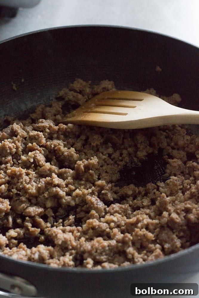 Step-by-step image showing ground pork breakfast sausage browning in a non-stick pan over medium heat, broken up with a wooden spoon.
