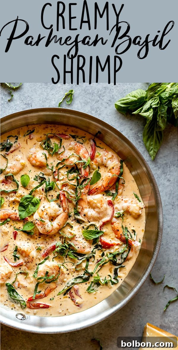 Close-up of creamy shrimp dish in a pan, highlighting the texture and vibrant colors of the sauce and ingredients.