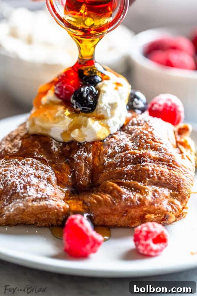 Overnight Croissant French Toast Strata 4 Individual serving of Croissant French Toast Bake topped with fresh berries and a drizzle of maple syrup