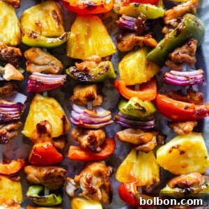 Delicious Pineapple Teriyaki Chicken Skewers beautifully plated and ready to be served, fresh off the grill.