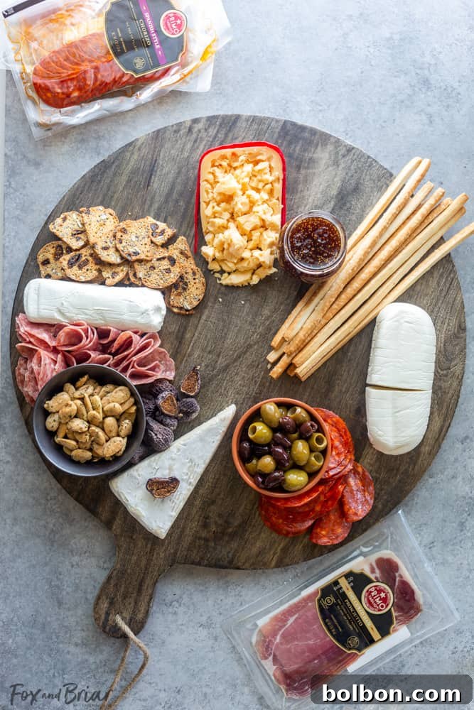 Another step-by-step image demonstrating how to artfully arrange folded salami and rolled prosciutto on a charcuterie board, enhancing its visual appeal.