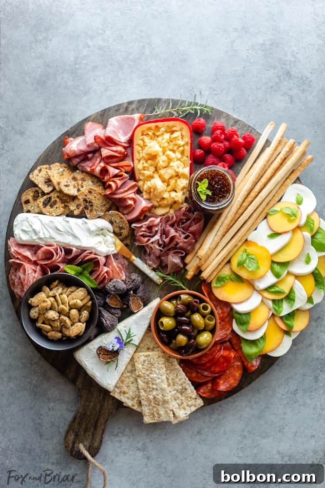 A close-up of the summer twist: a vibrant peach caprese salad with fresh mozzarella and basil, artfully arranged on the charcuterie board.