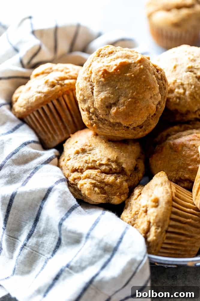 Wholesome Peanut Butter Banana Treats 3 Freshly baked peanut butter banana muffins on a cooling rack