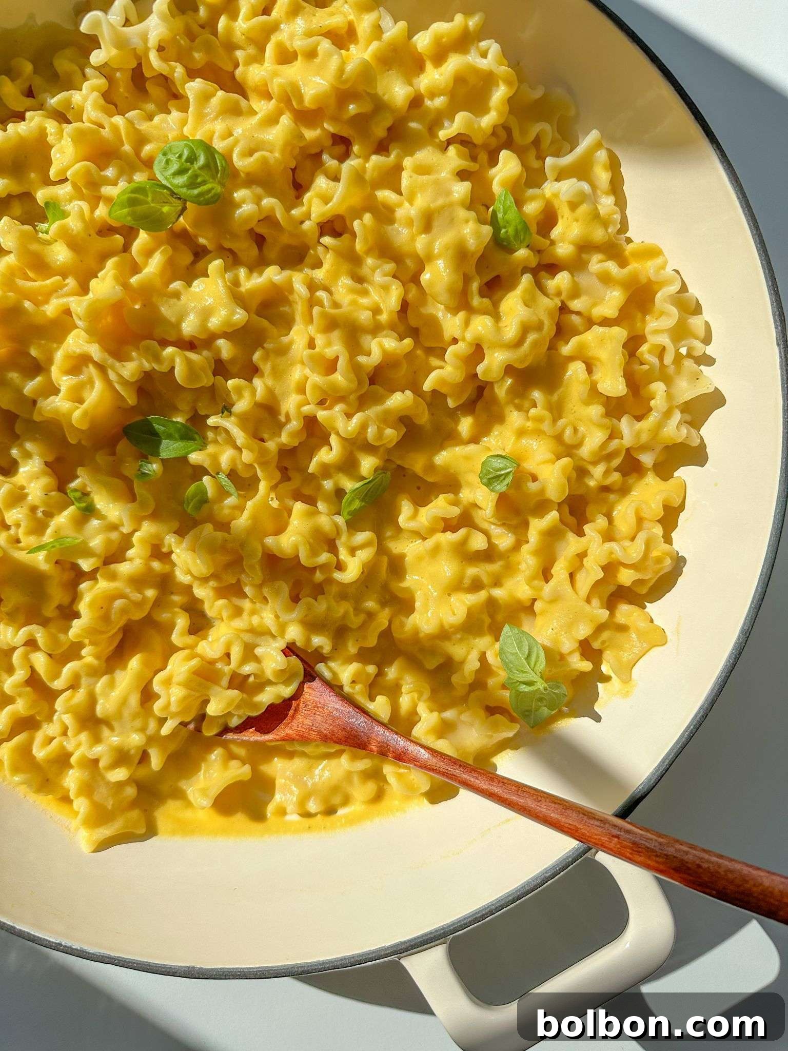 Creamy Butternut Squash Pasta in a white bowl, garnished with fresh herbs.