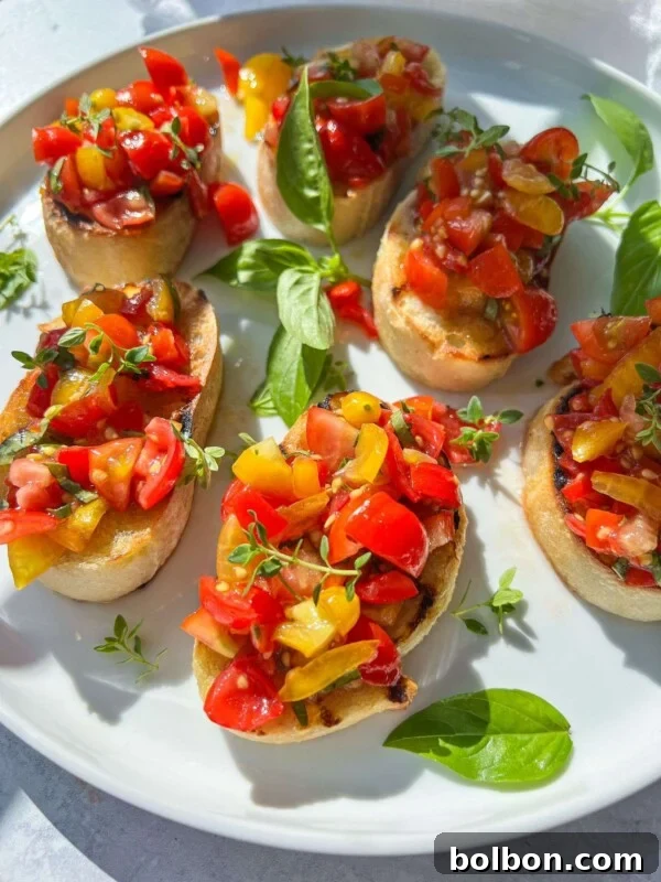 Pan con Tomate: Authentic Spanish Tomato Bread Recipe & How to Make It 3 A plate of Italian Bruschetta featuring toasted bread slices topped with diced red and yellow tomatoes, garnished with fresh basil leaves and microgreens, served on a white plate.