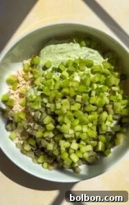 Bowl with diced cucumbers, green onions, and herb dressing