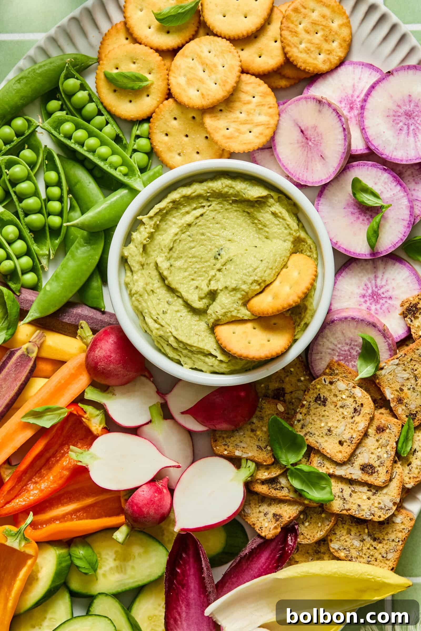 Creamy Tuna and Avocado Dip 2 Colorful vegetable platter with green hummus dip and crackers