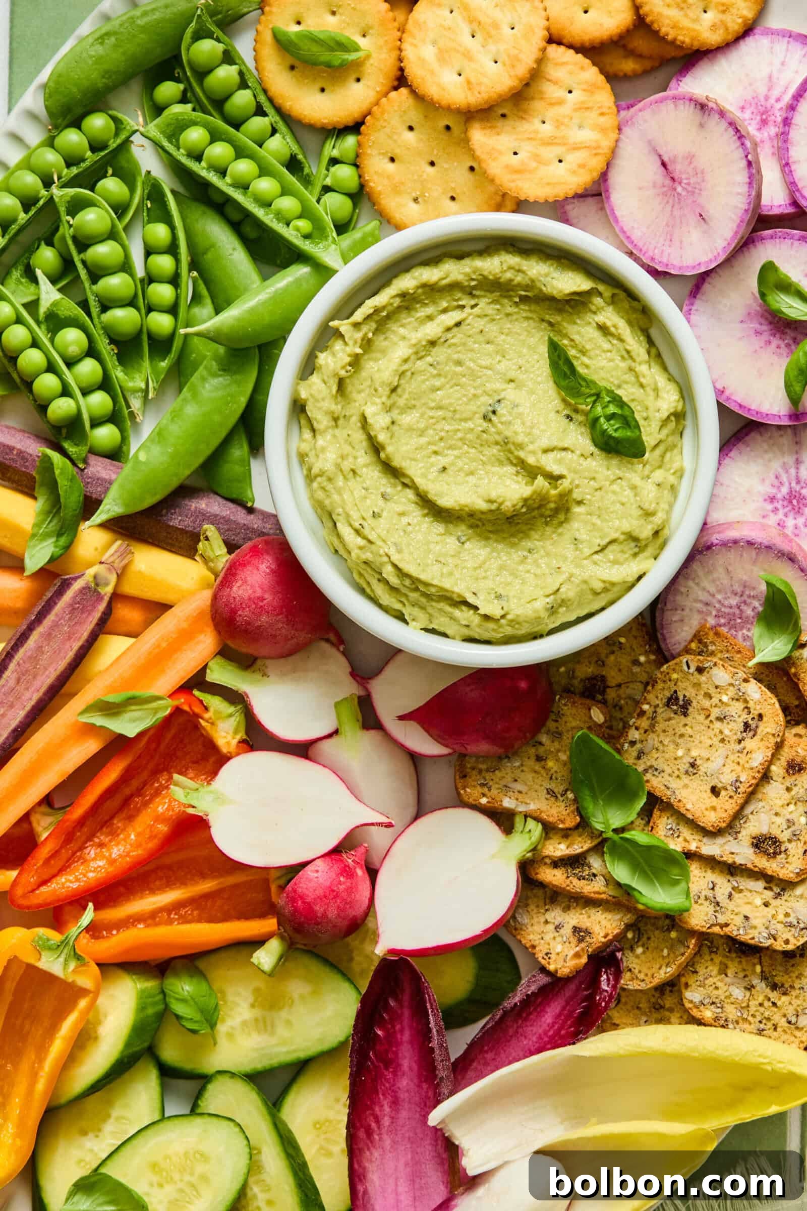 Creamy Tuna and Avocado Dip 5 Colorful vegetable platter with green avocado dip and crackers