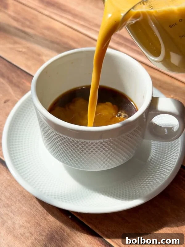 Homemade Pumpkin Creamer Recipe for Coffee 3 Pumpkin Creamer being poured into white cup