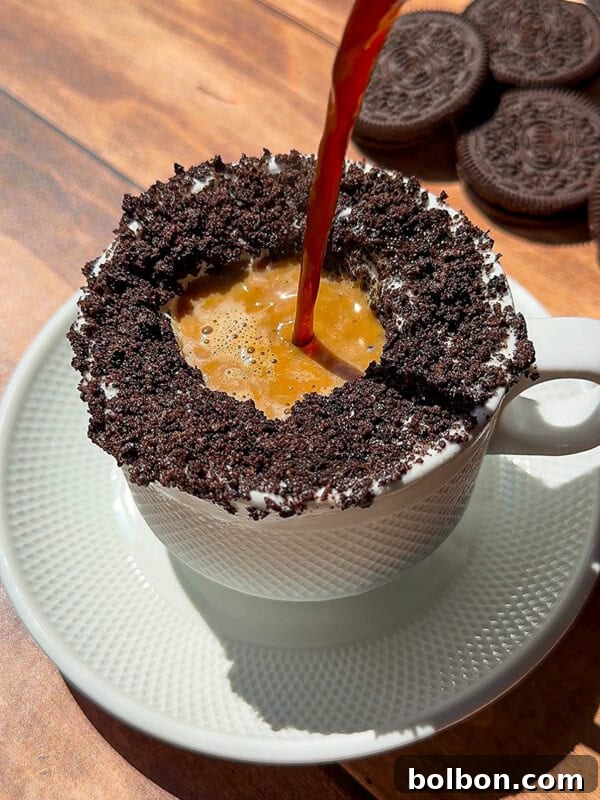 Espresso poured into Oreo cookie-rimmed coffee cup