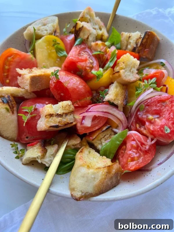 A bowl of Panzanella Salad with colorful tomato wedges